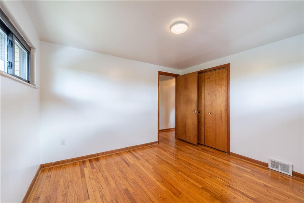 601 Hillcrest Avenue McKees Rocks, PA 15136 - Photo 18 of 32 a view of an empty room with wooden floor and a window