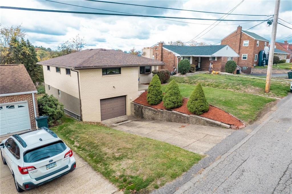 601 Hillcrest Avenue McKees Rocks, PA 15136 - Photo 2 of 32 a front view of a house with a garden and parking