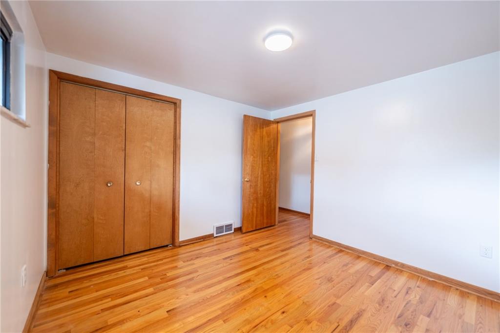 601 Hillcrest Avenue McKees Rocks, PA 15136 - Photo 21 of 32 wooden floor in an empty room with a window