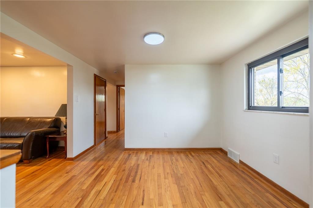 601 Hillcrest Avenue McKees Rocks, PA 15136 - Photo 6 of 32 an empty room with wooden floor and windows