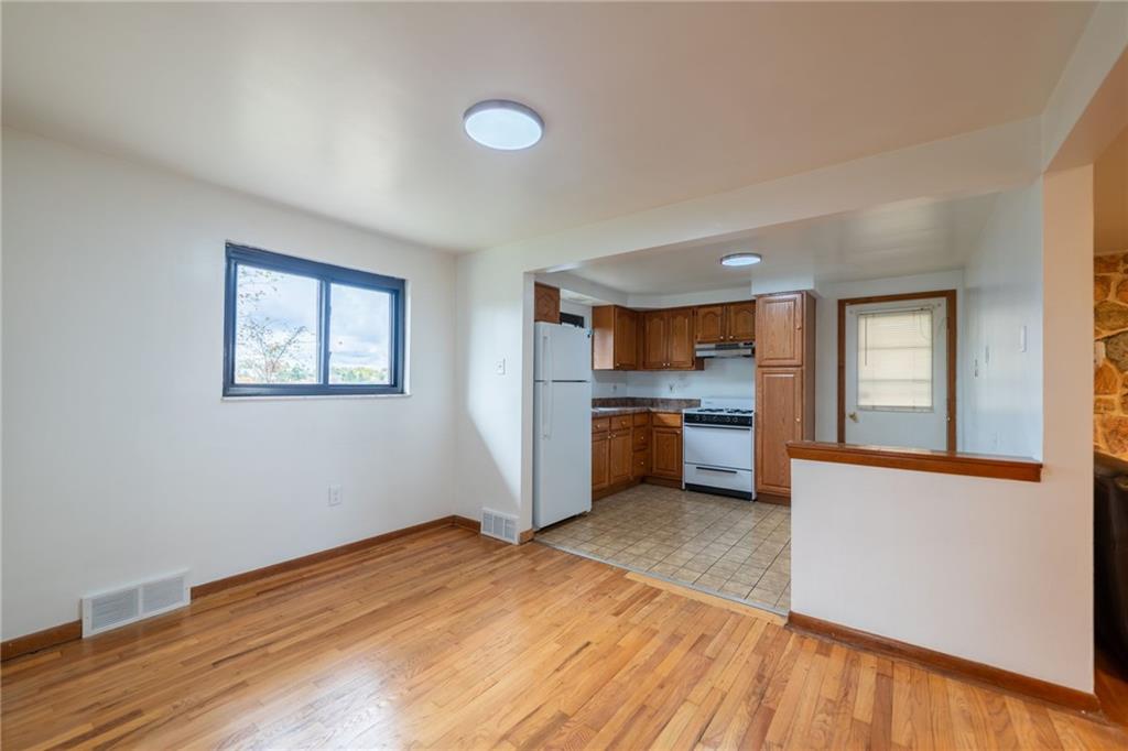 601 Hillcrest Avenue McKees Rocks, PA 15136 - Photo 9 of 32 a kitchen with stainless steel appliances granite countertop a stove and a refrigerator