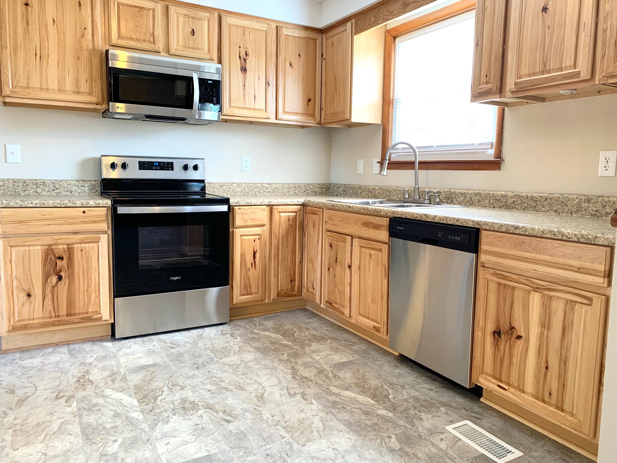 498 Bunker Hill Road Clarksville, TN 37042 - Photo 6 of 20 a kitchen with granite countertop a stove top oven microwave and cabinets