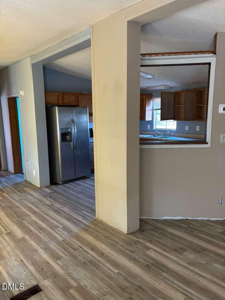 567 Miller Road Benson, NC 27504 - Photo 3 of 8 a view of a hallway with wooden floor and cabinet