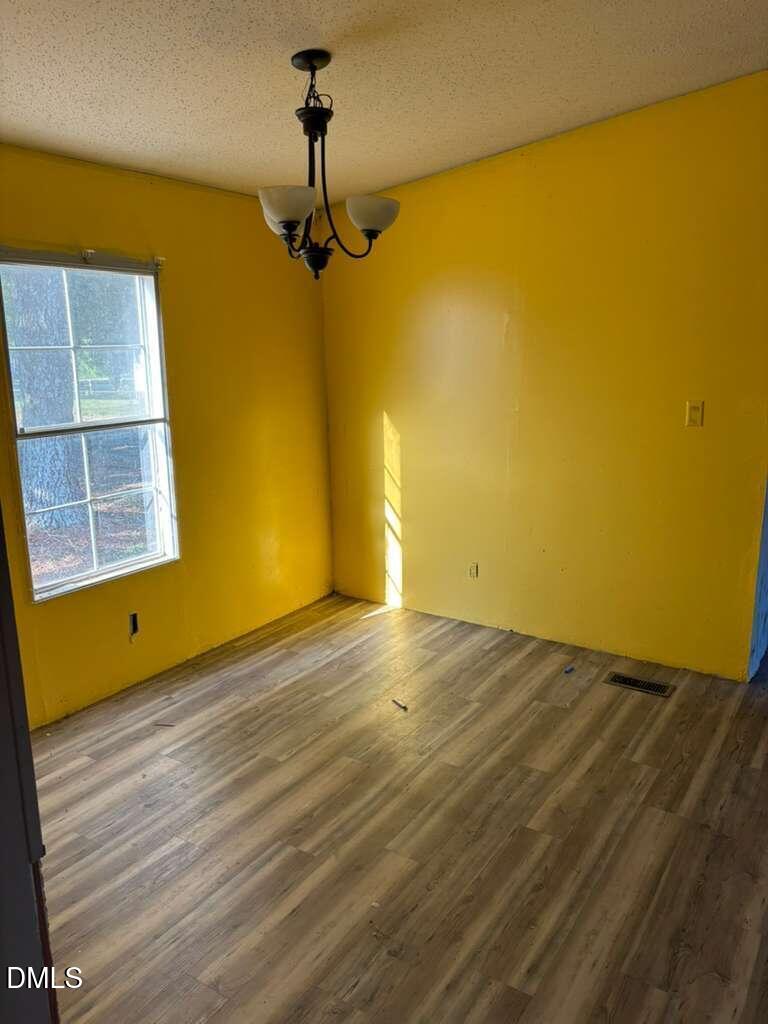 567 Miller Road Benson, NC 27504 - Photo 5 of 8 a view of a room with wooden floor and a ceiling fan