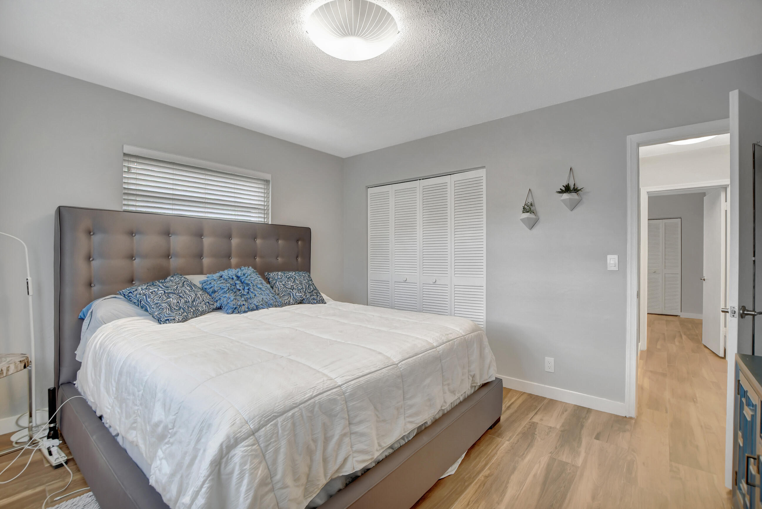 510 Silver Lane Boca Raton, FL 33432 - Photo 15 of 24 a bedroom with a bed and a chandelier