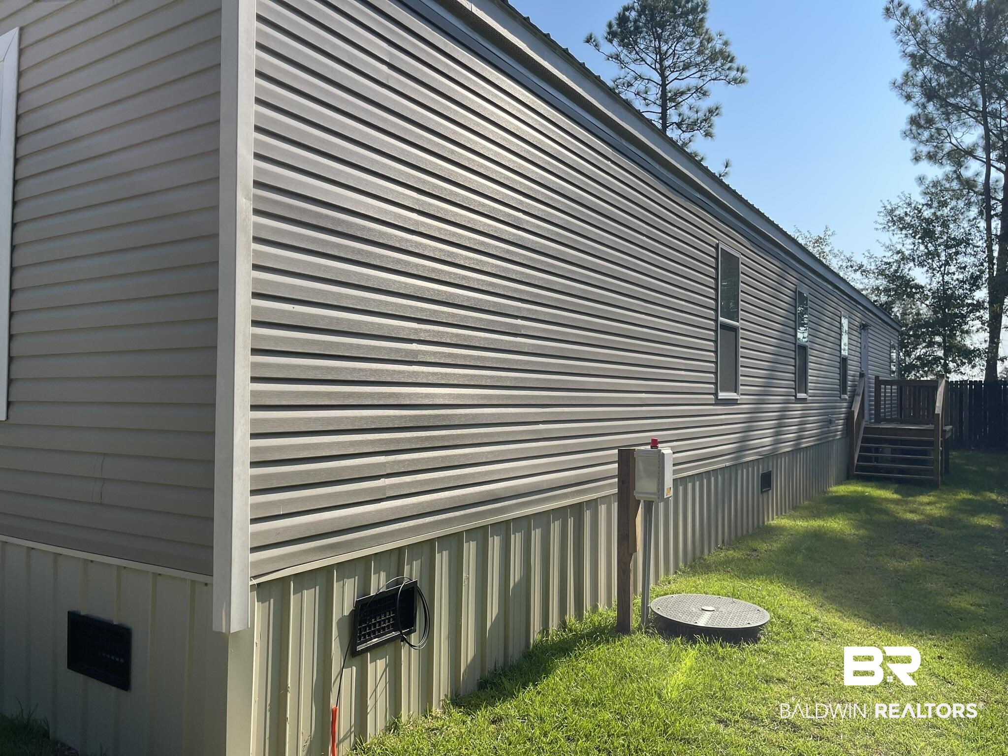 9202 Bay Pnes Road Elberta, AL 36530 - Photo 2 of 17 View of property exterior with a lawn