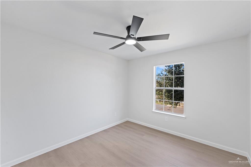 6300 North 21st Street McAllen, TX 78504 - Photo 12 of 19 an empty room with windows and fan