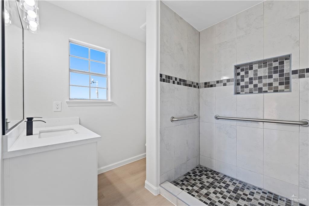 6300 North 21st Street McAllen, TX 78504 - Photo 16 of 19 a bathroom with a sink and a mirror