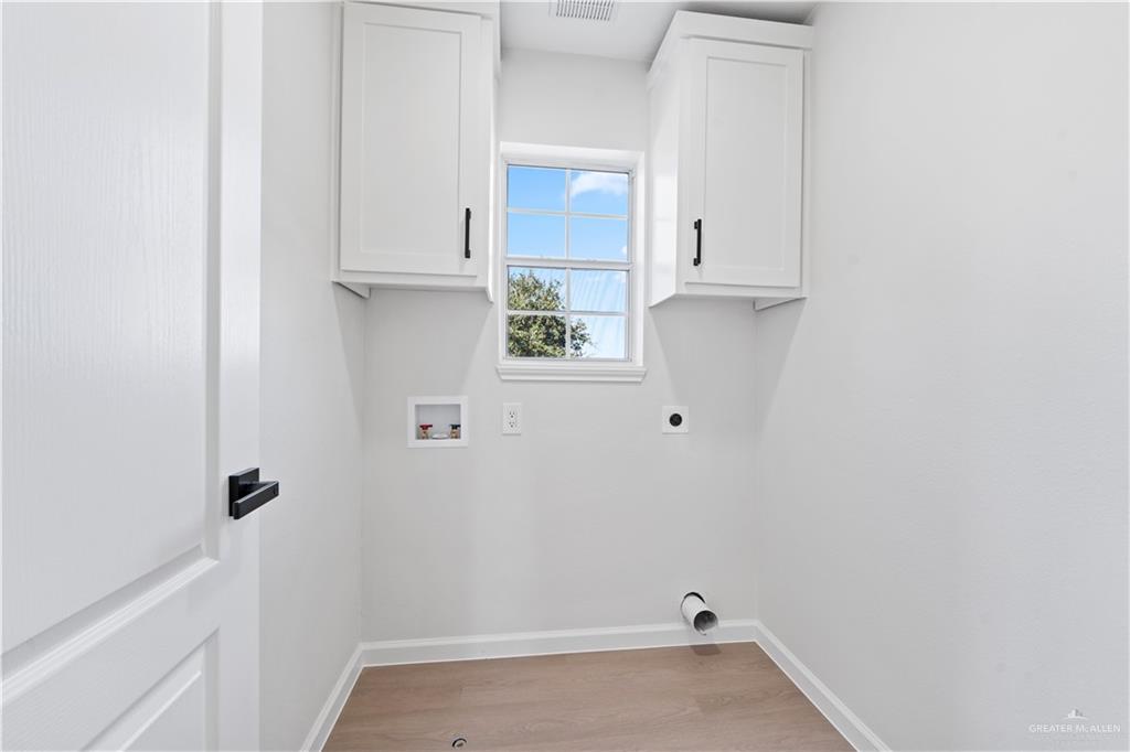 6300 North 21st Street McAllen, TX 78504 - Photo 17 of 19 a view of storage and utility room with a wooden floor