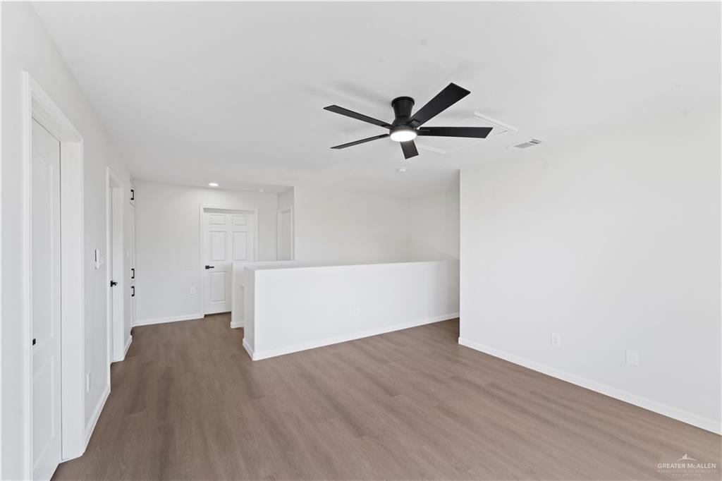 6300 North 21st Street McAllen, TX 78504 - Photo 10 of 19 a view of a big room with wooden floor and a ceiling fan