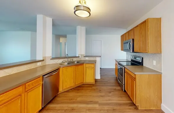 a kitchen with stainless steel appliances granite countertop a sink and a stove top oven