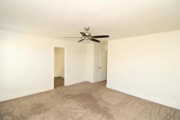 a view of a room with a ceiling fan