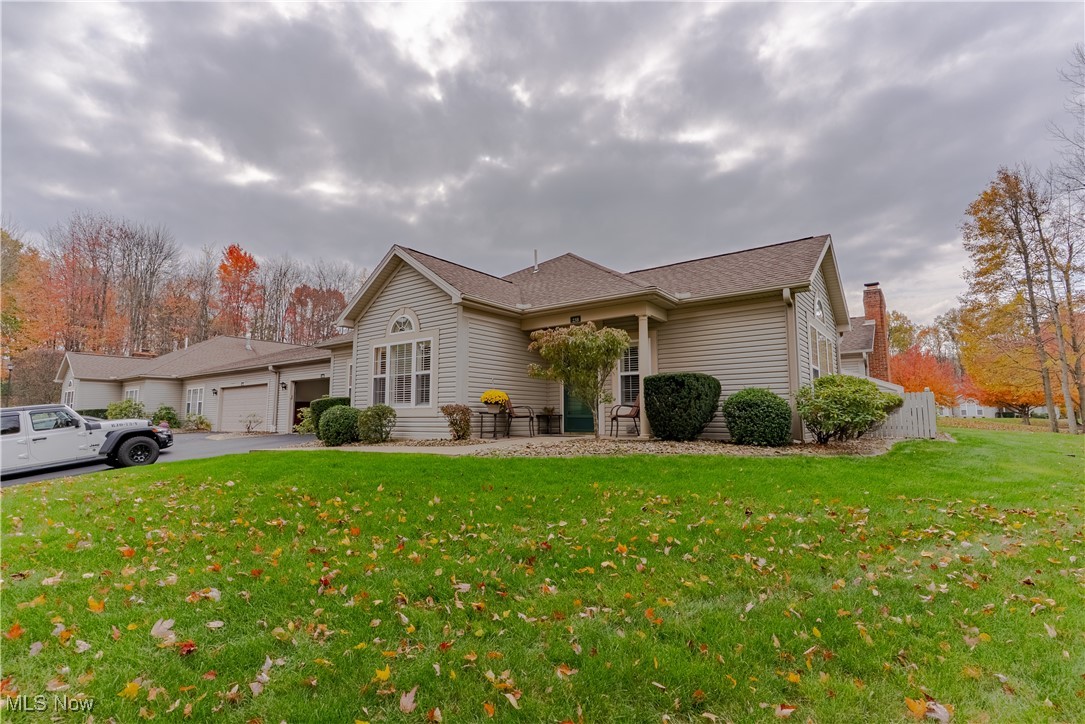 5645 Clingan Road, Unit 23B Struthers, OH 44471 - Photo 2 of 38 View of front of house with a front lawn, driveway, an attached garage, and a shingled roof