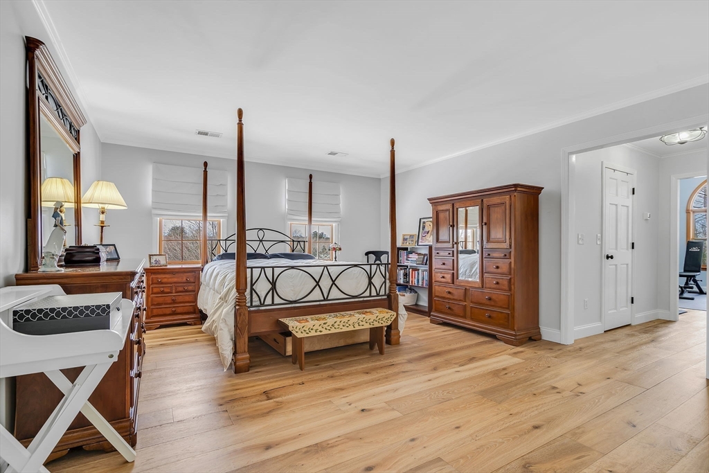 84 Jefferson Road Franklin, MA 02038 - Photo 21 of 39 a spacious bedroom with a bed a table and wooden floor