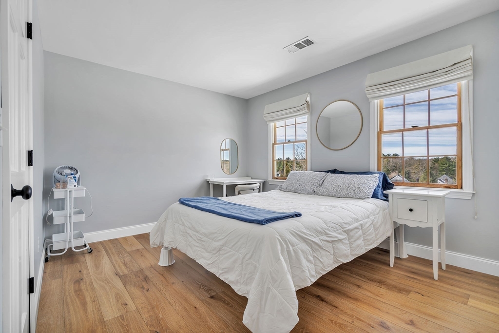 84 Jefferson Road Franklin, MA 02038 - Photo 28 of 39 a bedroom with a bed and wooden floor