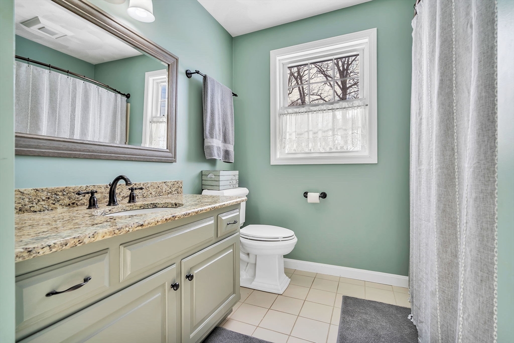 84 Jefferson Road Franklin, MA 02038 - Photo 29 of 39 a bathroom with a granite countertop toilet sink and mirror
