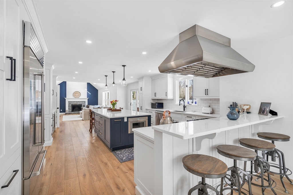 84 Jefferson Road Franklin, MA 02038 - Photo 10 of 39 a kitchen with stainless steel appliances a table and chairs in it