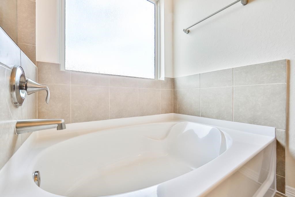 247 Sintra Lk Way Rosenberg, TX 77469 - Photo 18 of 28 a white bath tub sitting in a bathroom