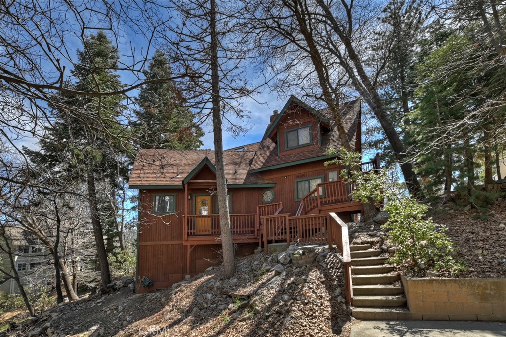 26285 Augusta Drive Lake Arrowhead, CA 92352 - Photo 1 of 47 a front view of a house with a garden