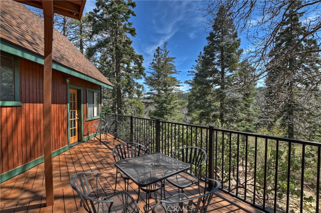 26285 Augusta Drive Lake Arrowhead, CA 92352 - Photo 14 of 47 a balcony with wooden floor and outdoor seating