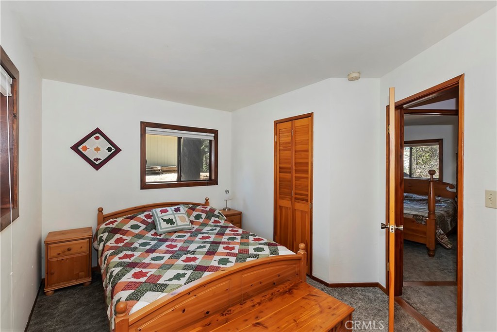 26285 Augusta Drive Lake Arrowhead, CA 92352 - Photo 24 of 47 a bedroom with natural light and a bed