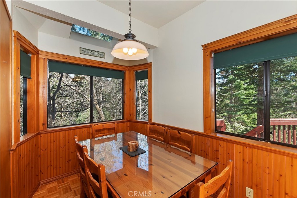 26285 Augusta Drive Lake Arrowhead, CA 92352 - Photo 3 of 47 a view of a large kitchen with a large window and a table