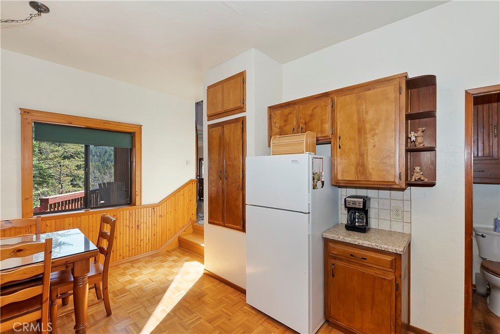 26285 Augusta Drive Lake Arrowhead, CA 92352 - Photo 33 of 47 a kitchen with stainless steel appliances granite countertop a refrigerator and a stove top oven