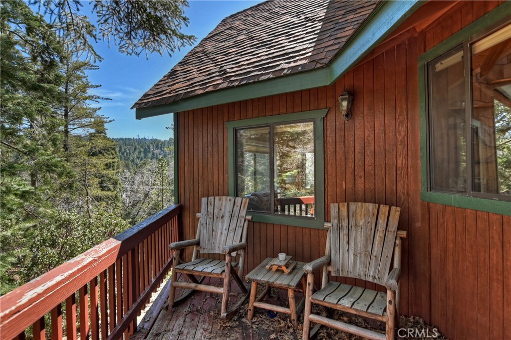 26285 Augusta Drive Lake Arrowhead, CA 92352 - Photo 45 of 47 a view of a wooden chairs and bench in the balcony