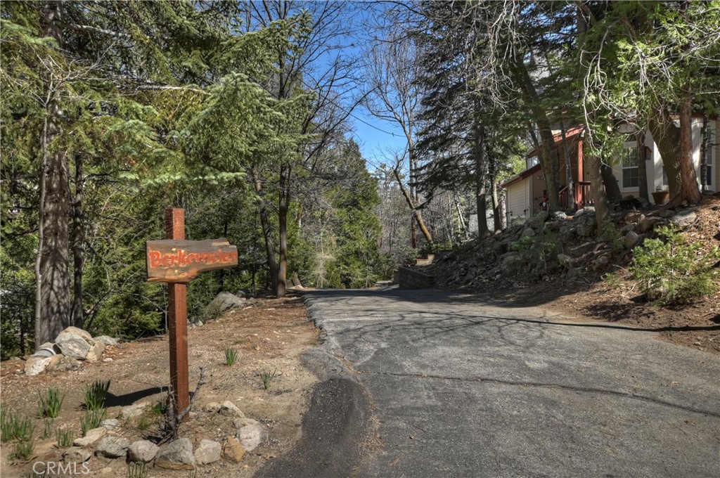 26285 Augusta Drive Lake Arrowhead, CA 92352 - Photo 47 of 47 a street sign on a sidewalk next to a road