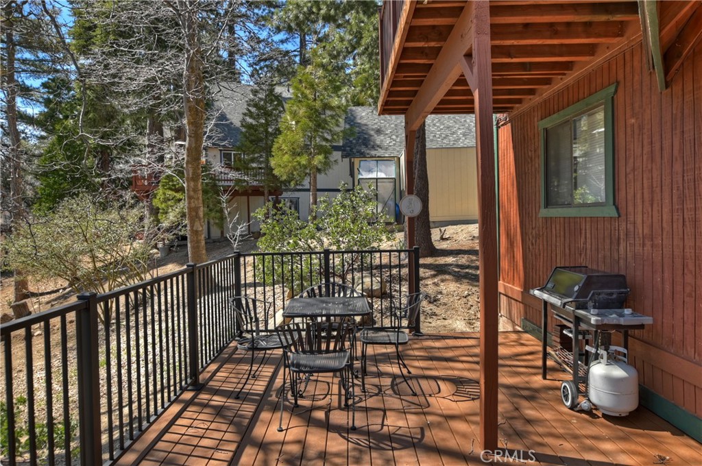 26285 Augusta Drive Lake Arrowhead, CA 92352 - Photo 9 of 47 a balcony with chairs and wooden floor