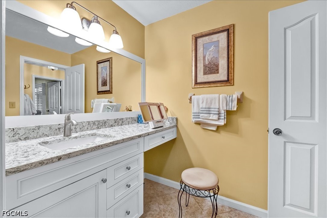 707 Hoover Dike Road, Unit 904 Clewiston, FL 33440 - Photo 32 of 41 a bathroom with a granite countertop sink and a mirror