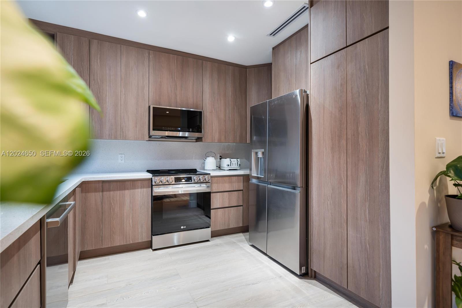 1663 Southwest 13th Street Miami, FL 33145 - Photo 66 of 112 a kitchen with stainless steel appliances granite countertop a refrigerator and a stove