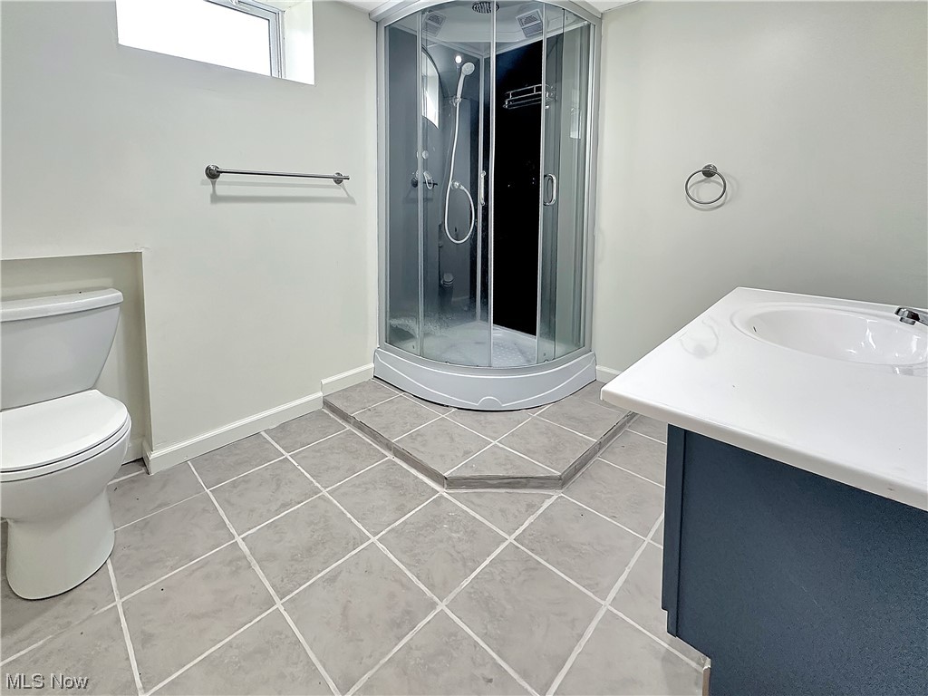 2692 Race Track Road New Cumberland, WV 26047 - Photo 20 of 25 Bathroom with tile floors, toilet, vanity, and walk in shower