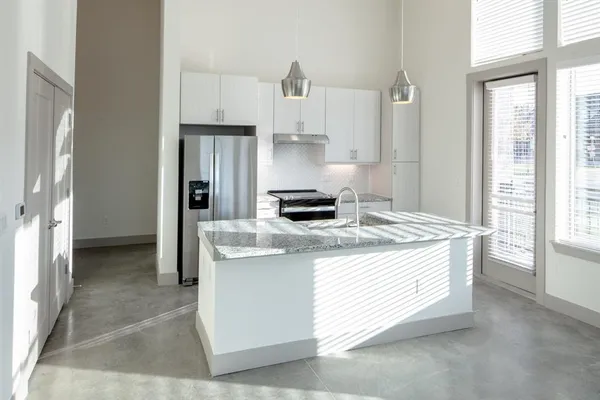 a kitchen with a stove a refrigerator and a stove