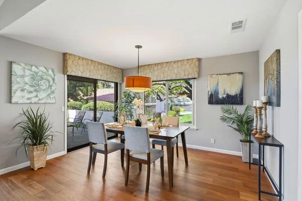 a view of a dining room with furniture window and wooden floor