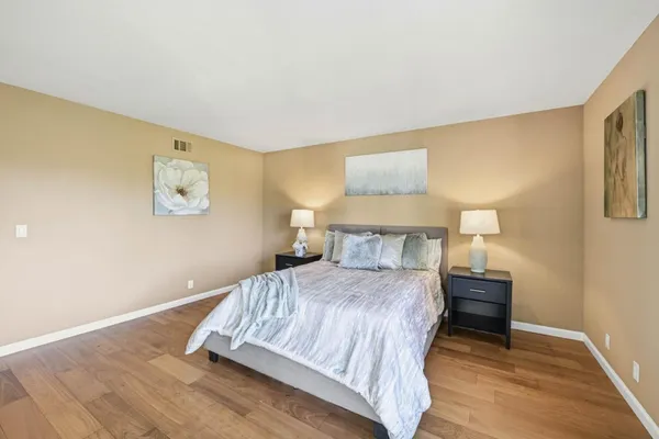 a spacious bedroom with a bed and window