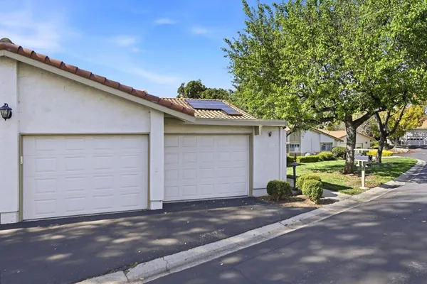 a view of a garage with a tree