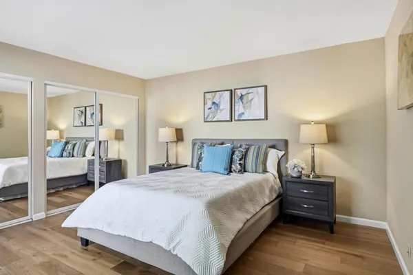 a bedroom with a bed and a painting on the wall