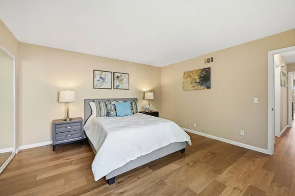 a bedroom with a bed and a large window with outer view