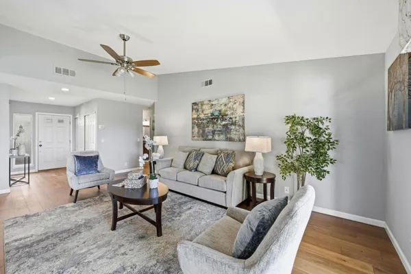 a living room with furniture and wooden floor