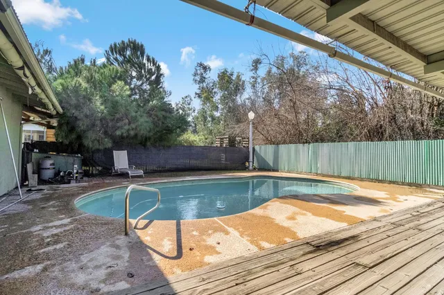 a backyard of a house with plants and garden