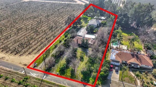 an aerial view of a house with a yard and garden