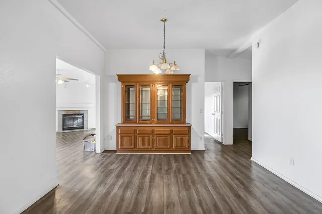 a view of a kitchen with wooden floor and a ceiling fan