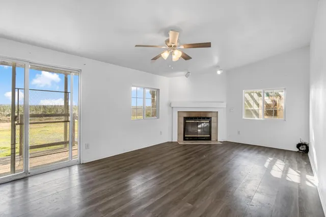 a view of a kitchen with wooden floor and a window