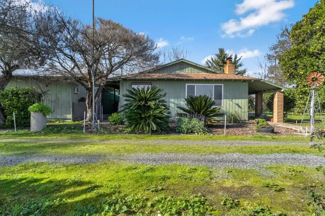 an empty room with wooden floor and fireplace