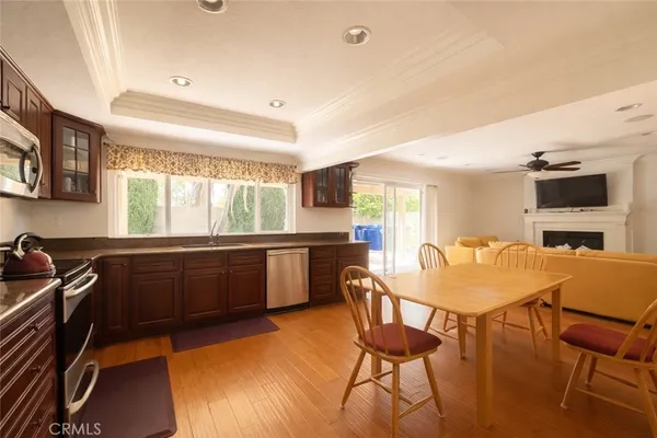 a kitchen with a table chairs sink and cabinets
