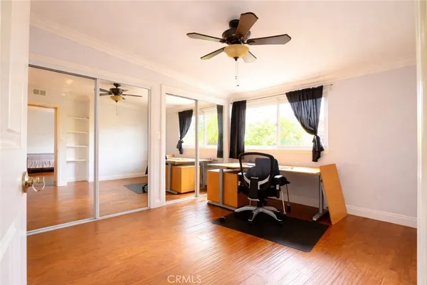 a view of workspace with wooden floor windows