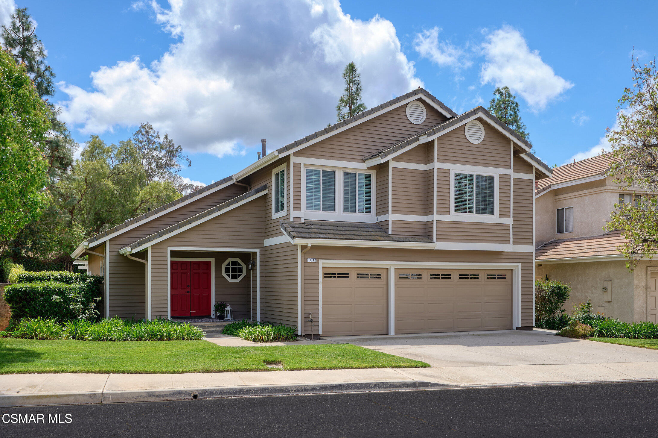 12142 Cherry Grove Street Moorpark, CA 93021 - Photo 1 of 36 a front view of a house with a garden and yard