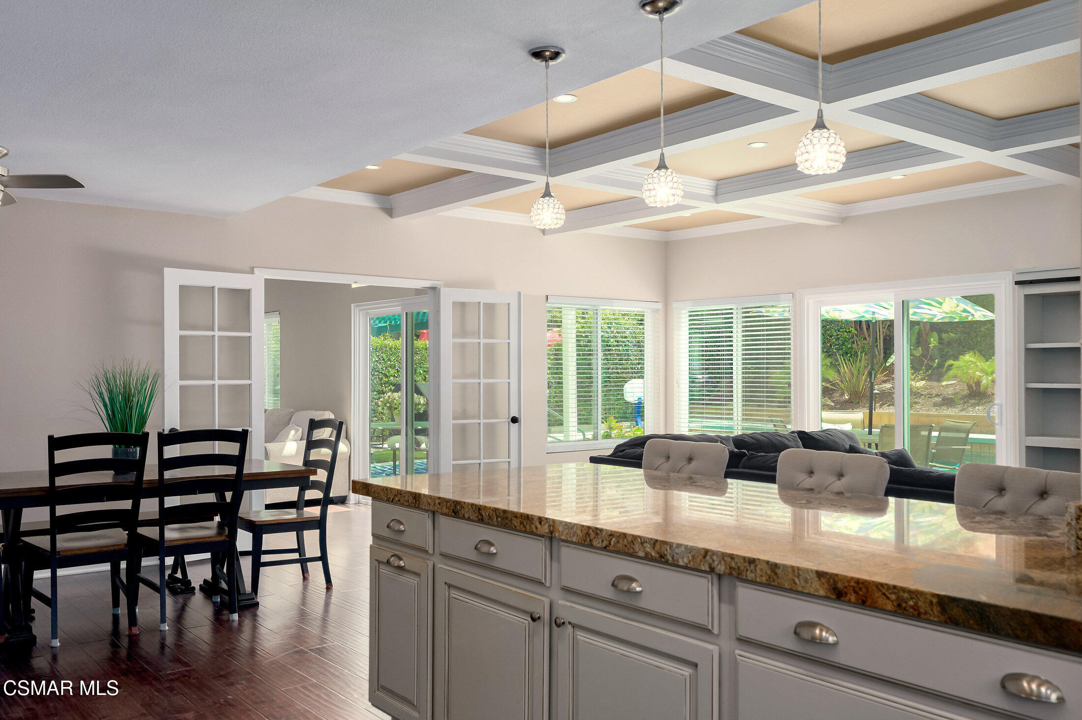 12142 Cherry Grove Street Moorpark, CA 93021 - Photo 11 of 36 a kitchen with granite countertop lots of counter space dining table and chairs