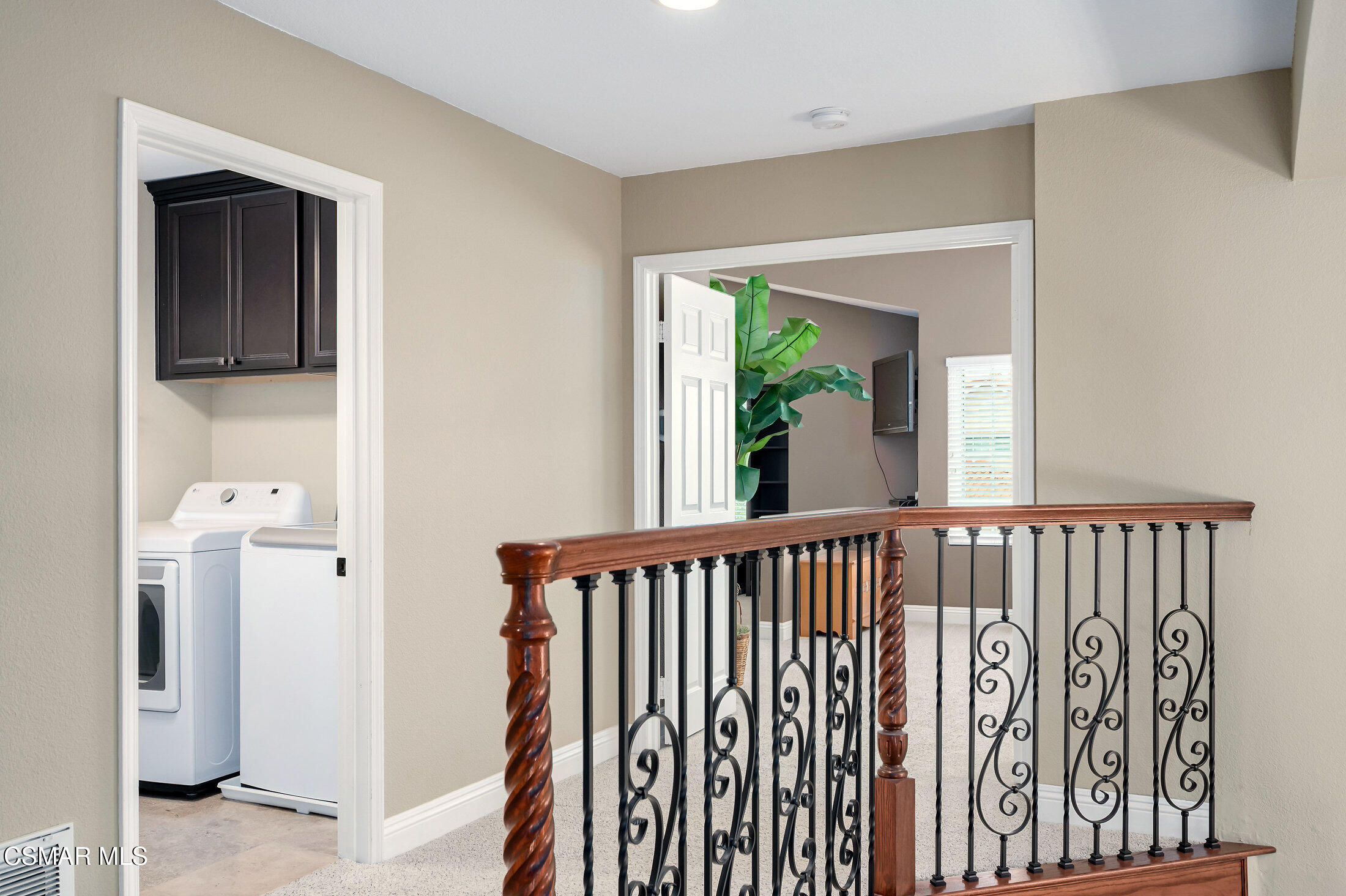 12142 Cherry Grove Street Moorpark, CA 93021 - Photo 16 of 36 a view of a hallway with wooden floor and windows